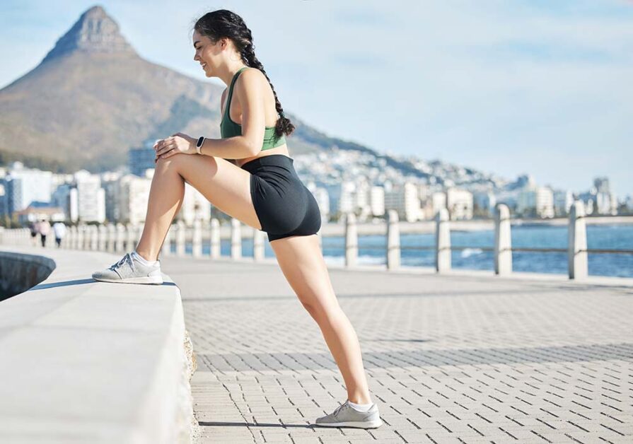 Athlete stretching outdoors representing mindfulness, recovery, and resilience.