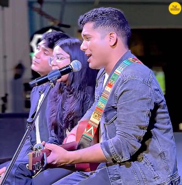 Young Indian singer leading mindful bhajan jamming session on stage