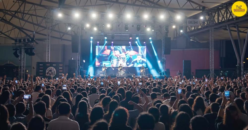 Massive Indian youth crowd cheering during bhajan jamming concert