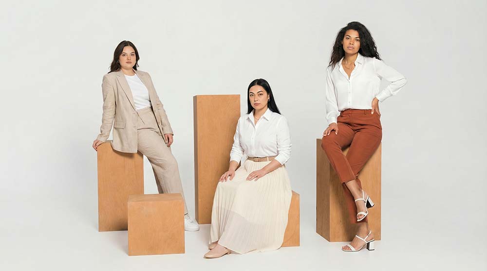 Neutral tailored wardrobe essentials arranged in minimalist budget fashion flat lay