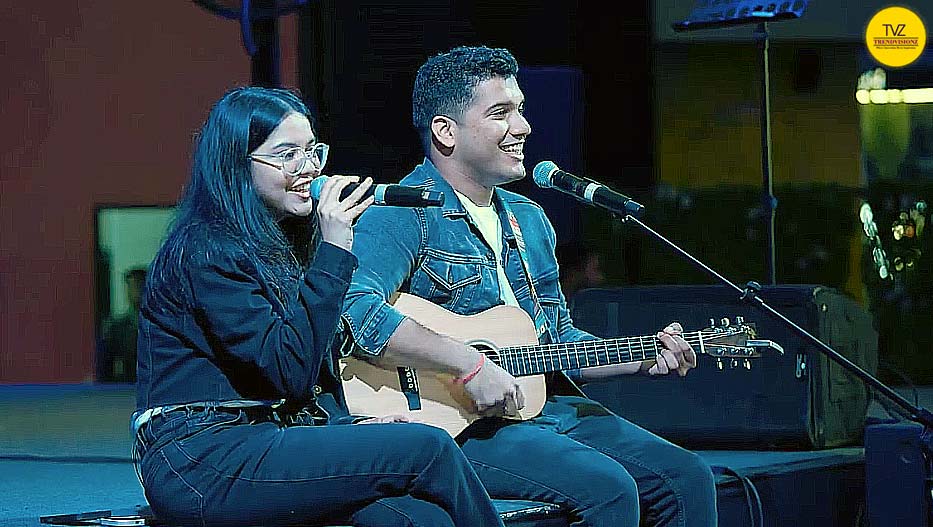 Acoustic sibling duo performing devotional music live on stage