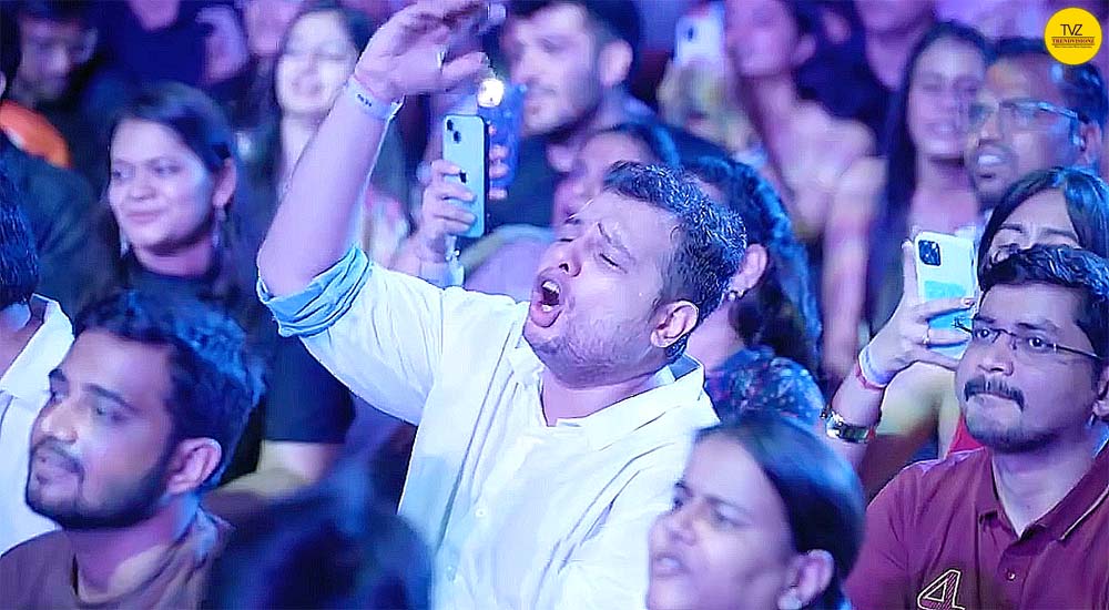 Young Indian crowd singing together at peaceful bhajan night