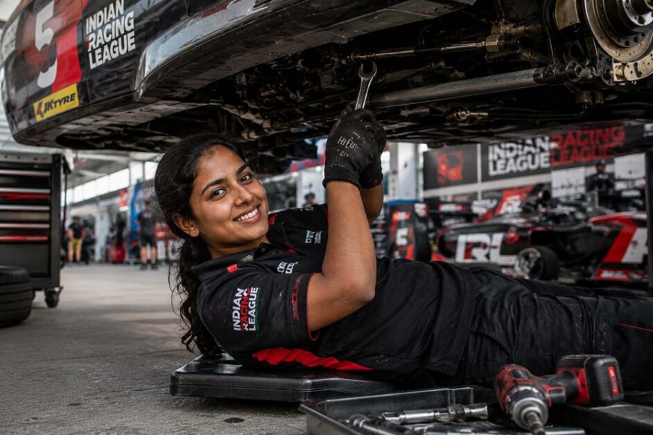 Woman race engineer working beneath race car in India