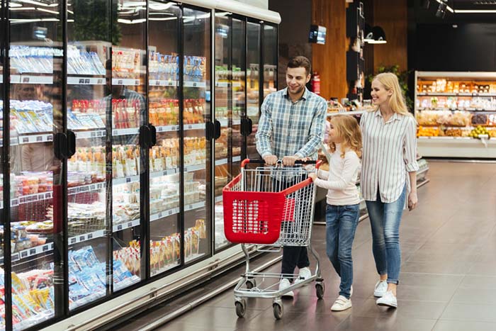 A happy family of conscious consumers shopping sustainably at supermarket