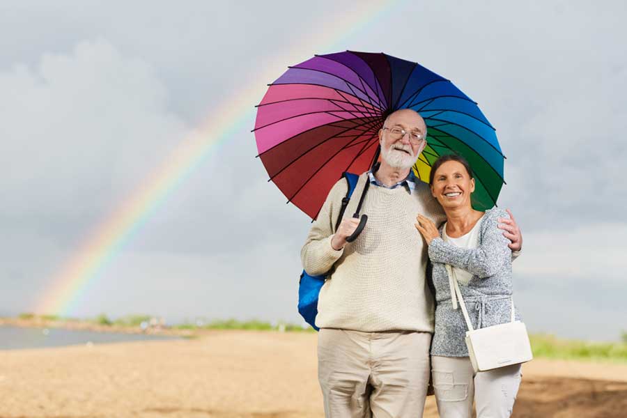 An Old Couple Finding Meaningful Connection Beneath a Rainbow