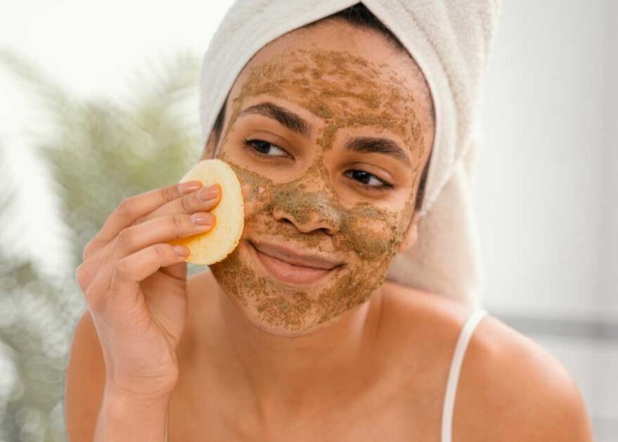 lady exfoliating to remove dead skin cells.