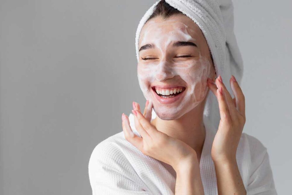 Woman using a facial skincare product.