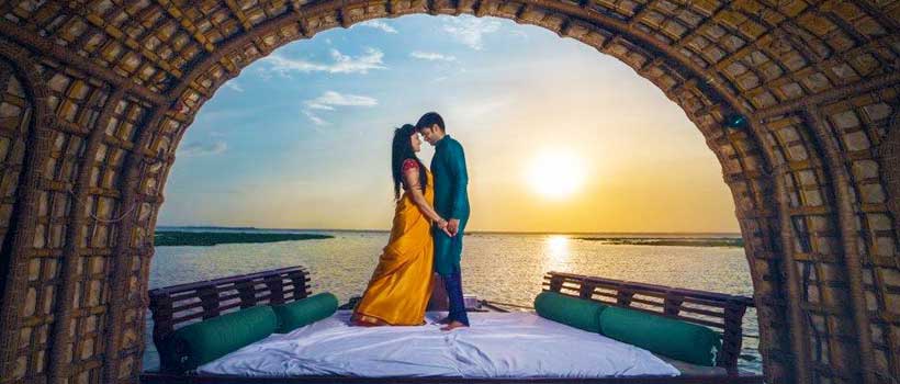 Traveling Couples exploring Kerala's tranquil backwaters on a houseboat.