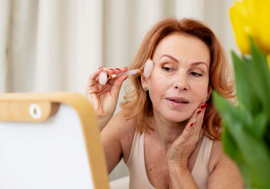 Woman doing a facial treatment, for aging skin care needs.