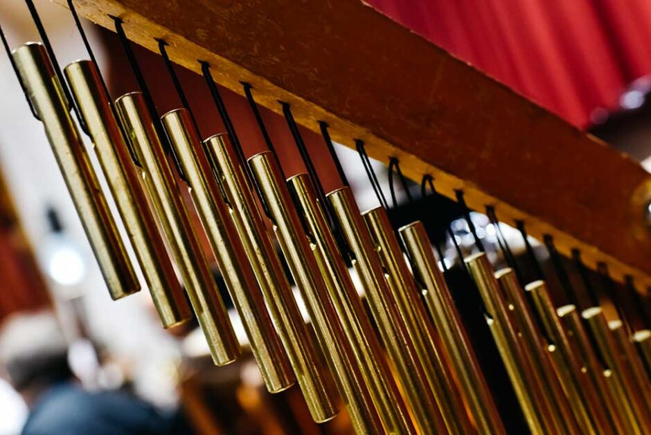 Close-up of golden wind chimes used for sound healing