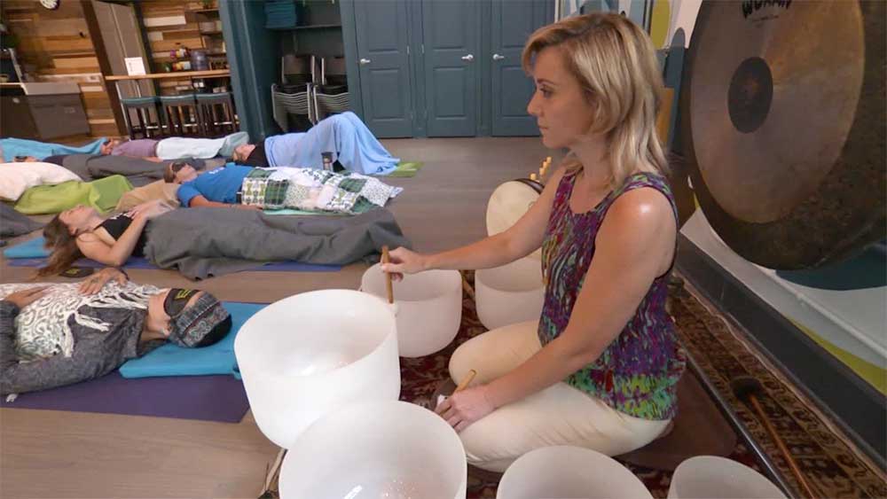 A group enjoying a sound bath performed by healing practitioner