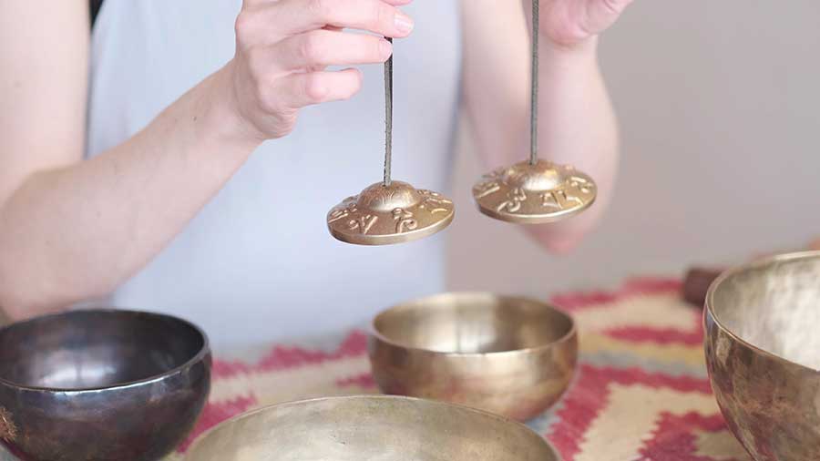 Woman meditating at home, practicing yoga for relaxation and healing.