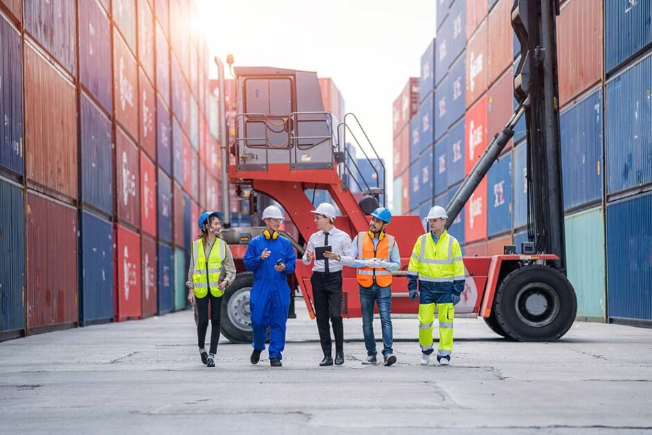 Logistics team discussing freight forwarding at an international shipping hub