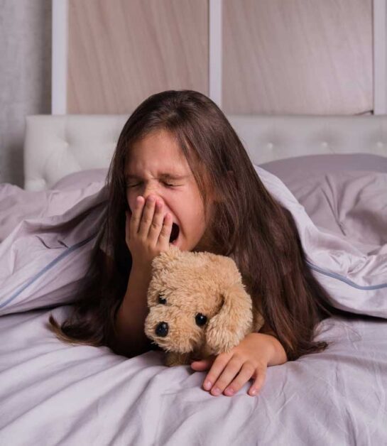 A child struggling to sleep after consuming sugary bedtime snacks.