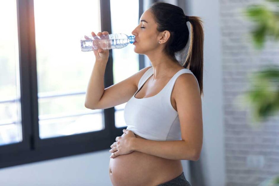 a lady drinking water to relieve morning sickness