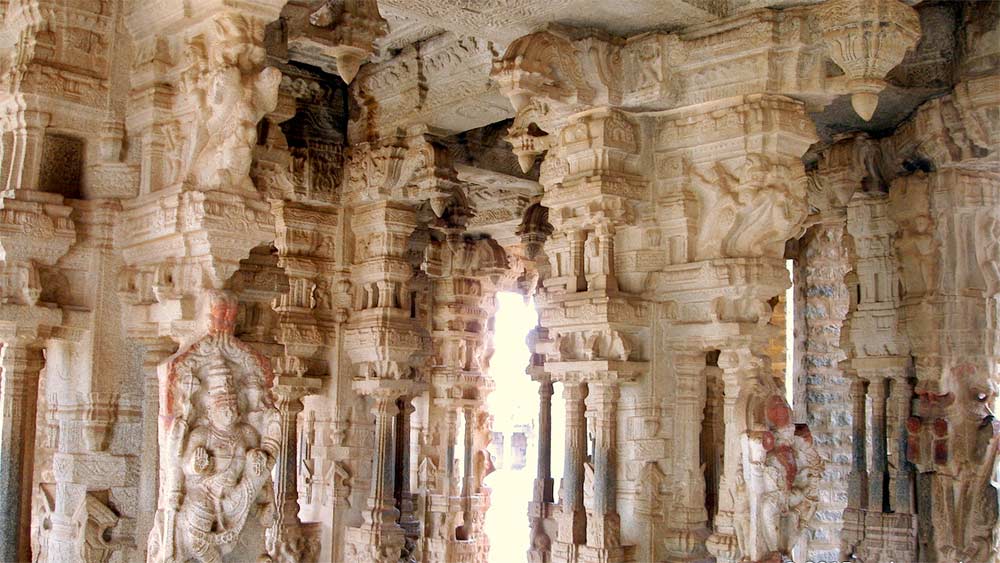 Detailed carvings on temple pillars showcasing Vijayanagara architecture in Hampi.