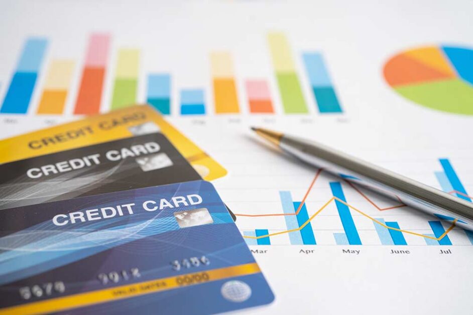 Credit cards placed on financial charts showing credit score analysis