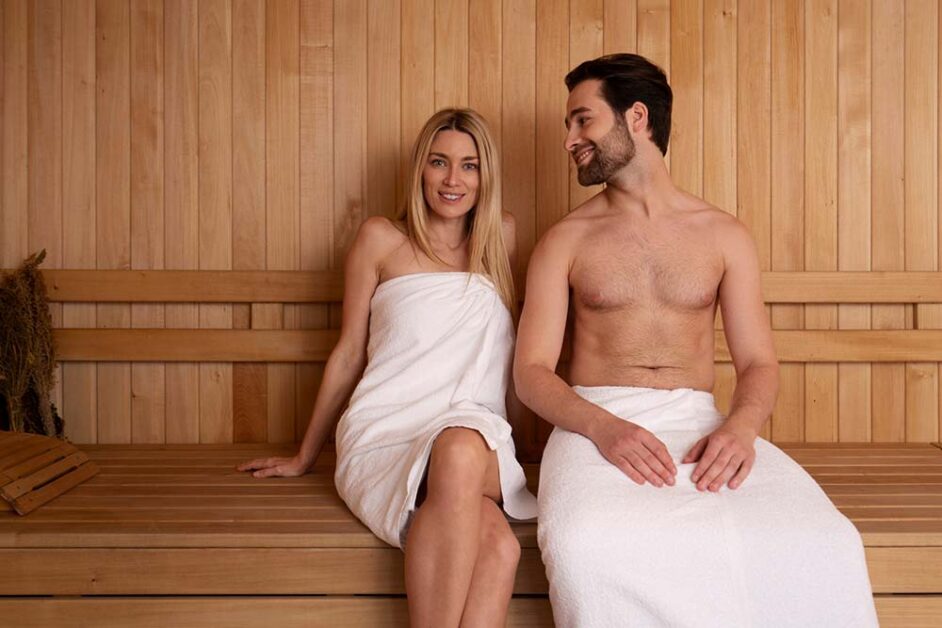 Spacious wooden sauna with couples, symbolising urban wellness trend
