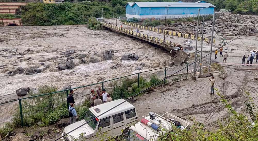 Cloudburst flash floods destroying bridge in Uttarakhand, people observing damage