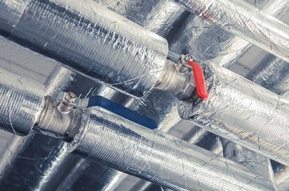 Industrial insulated metal pipes with red and blue valves