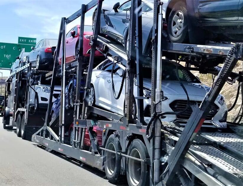 open car carrier trailer transporting multiple vehicles in USA