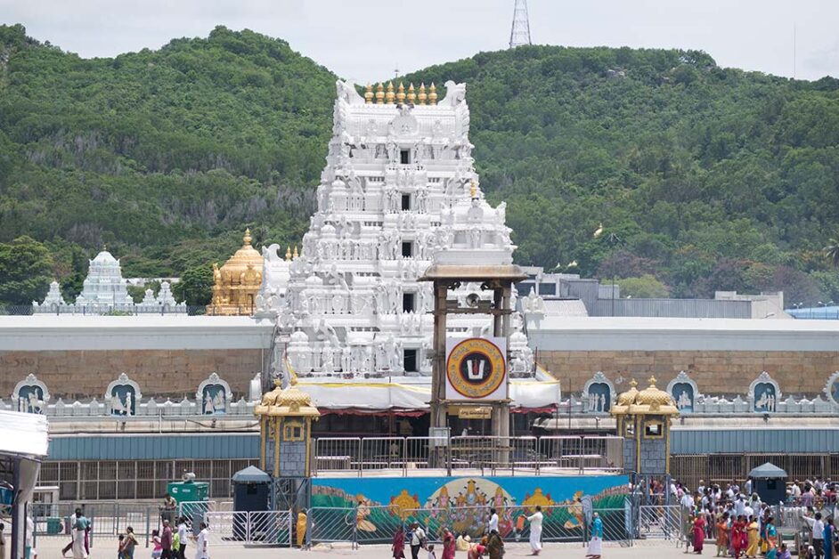 Front view of Tirumala Temple with pilgrims and surrounding hills