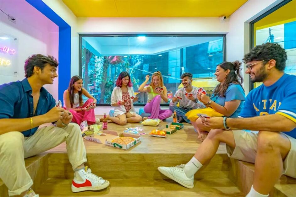 Young Indian travellers enjoying games together in The Hosteller lounge.