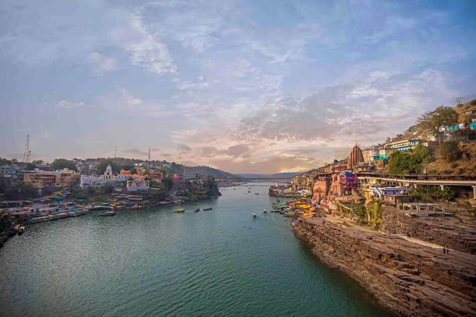 Omkareshwar temple island on Narmada River during serene sunset