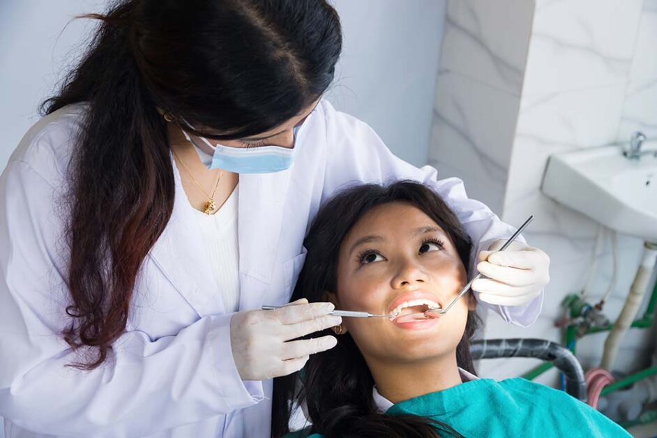 Dentist examining patient during early dental diagnosis appointment