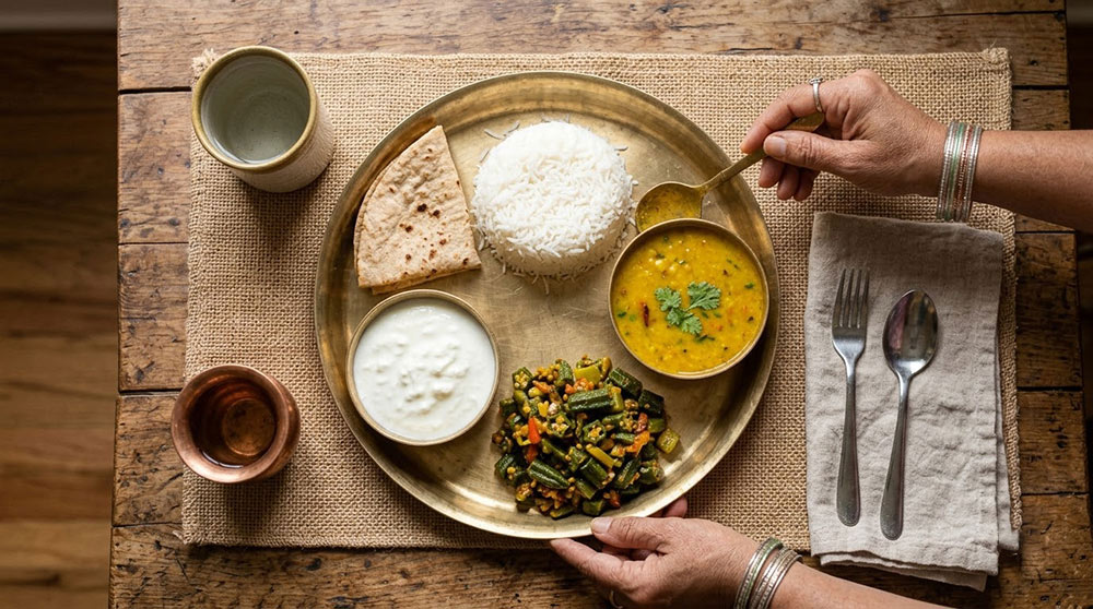 Balanced Indian meal combines measured carbohydrates, protein, curd and vegetables.