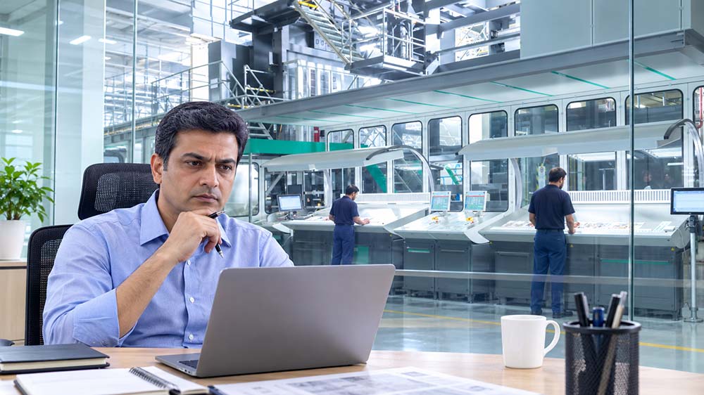 Senior manager reviewing printing press maintenance and operational reliability in pressroom