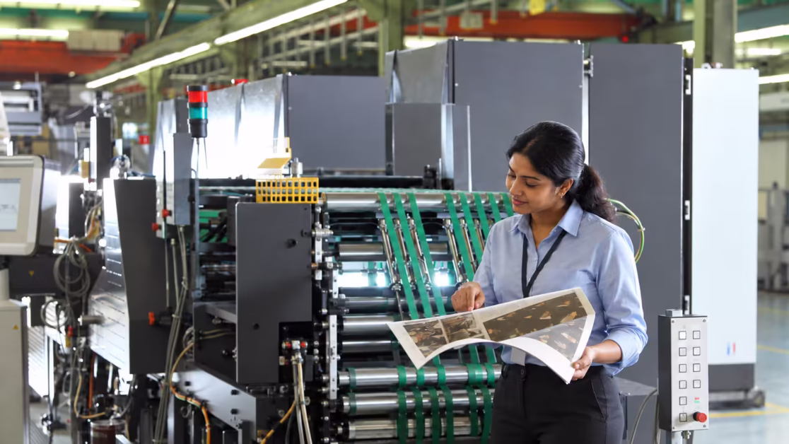 Newspaper press performance with Indian manager checking print on press